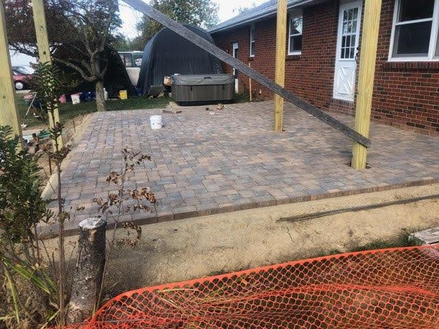 Brick paver patio with pergola structure by Mark Monnette Masonry