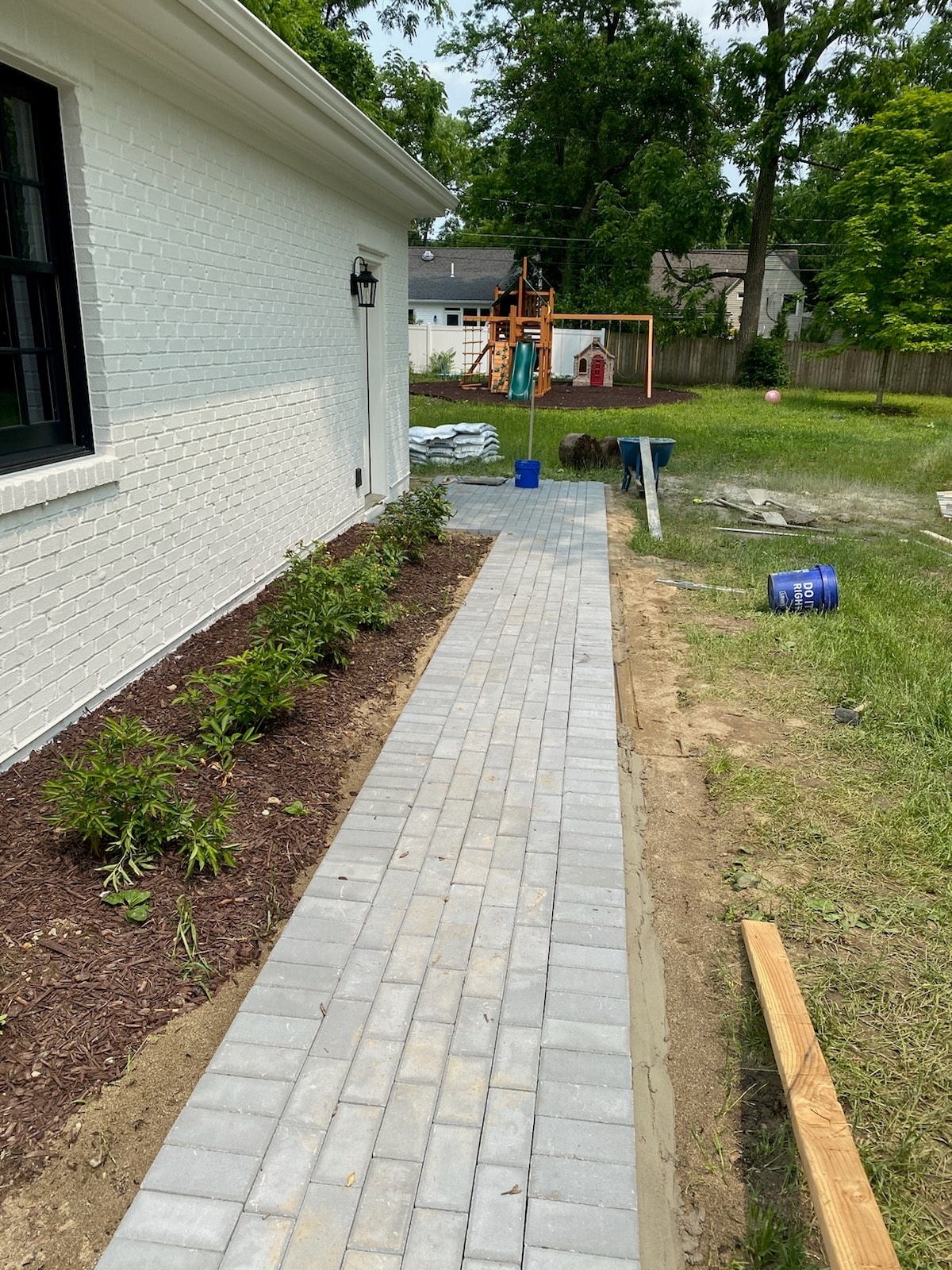 New paver walkway alongside brick home by Mark Monnette Masonry